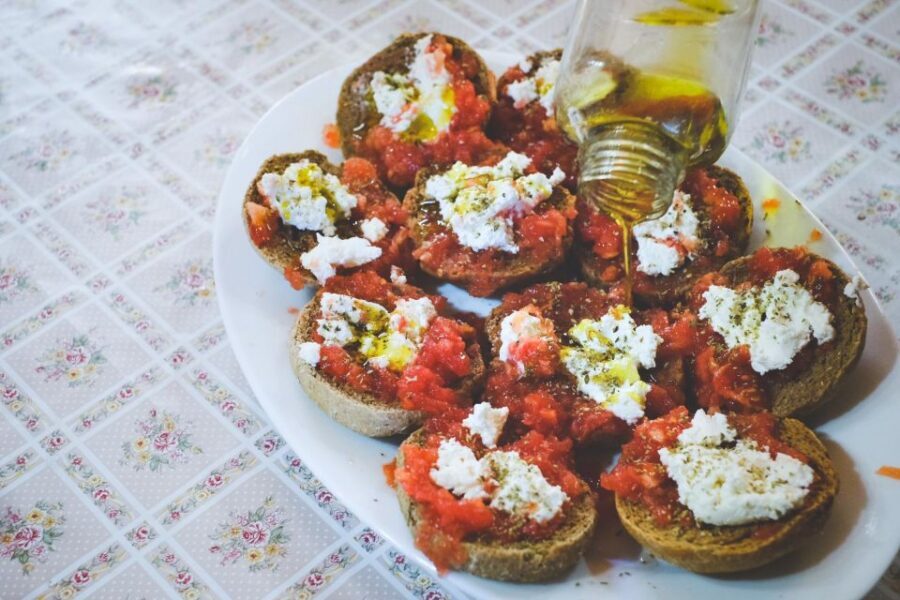 Chania: Authentic Cooking Class - Eating Cretan style: wine, raki, dessert, and a table that feels like family
